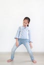 Funny face expression asian little child girl in white room. Full length Royalty Free Stock Photo