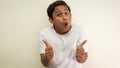 Funny face expression of young Asian Malay man in white t-shirt showing double thumbs up Royalty Free Stock Photo