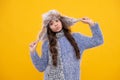 Funny face. Fashion happy young woman in knitted hat and sweater having fun over colorful blue background. Royalty Free Stock Photo