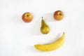 Funny face of fruit on a white background. Fresh fruit - apples, pears, bananas. The concept of proper nutrition, vegetarianism, f Royalty Free Stock Photo