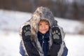 Funny face of little boy on snow winter nature. Funny kid in winter clothes. Children play outdoors in snow. Kids Royalty Free Stock Photo