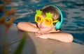 Funny face of little boy in funny sunglasses in pool in sunny day. Summer kids holidays. Royalty Free Stock Photo