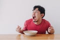 Funny face of man eat very hot and spicy instant noodle. Royalty Free Stock Photo