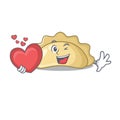 Funny Face pierogi cartoon character holding a heart Royalty Free Stock Photo