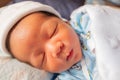 The funny face of sleeping newborn baby infant on the bed in the morning Royalty Free Stock Photo