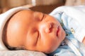 The funny face of sleeping newborn baby infant on the bed in the morning Royalty Free Stock Photo