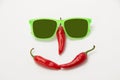 Funny face with a smile of sunglasses and hot chili peppers on a Royalty Free Stock Photo