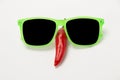 Funny face with a smile of sunglasses and hot chili peppers on a Royalty Free Stock Photo