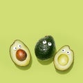 Funny faces avocados on a pastel green background Royalty Free Stock Photo