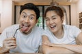 Funny faces lovely couple man and woman in white t-shirt in coffee shop. Royalty Free Stock Photo