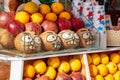 Funny faces painted on coconuts on the counter of a fruit stand