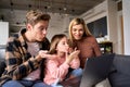 Funny family video calling using laptop computer at home. Royalty Free Stock Photo