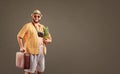 A funny fat bearded tourist with a pineapple and a suitcase smil