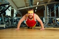 A funny fat man with a beard in the gym Royalty Free Stock Photo