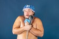 Funny fat man in blue cap sing in the shower Royalty Free Stock Photo