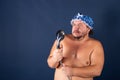 Funny fat man in blue cap sing in the shower Royalty Free Stock Photo