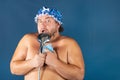 Funny fat man in blue cap sing in the shower Royalty Free Stock Photo