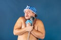 Funny fat man in blue cap sing in the shower Royalty Free Stock Photo