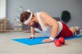 Funny fat man doing exercises on the floor smiling on the floor at home. Royalty Free Stock Photo