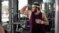 Funny fat man looking at mirror reflection gym and posing, pretending muscular Royalty Free Stock Photo