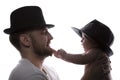 Funny father and kid in classic hats in backlight