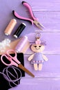 Funny felt doll keychain. Sewing supplies for toys. DIY kids embroidery inspiration. Top view Royalty Free Stock Photo