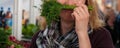 Funny female cook making fake mustache out of fresh dill Royalty Free Stock Photo