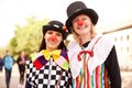 Funny and festive. Portrait of two young women dressed up as clowns at an outdoor festival.