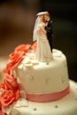 Funny figurines suite at a luxury wedding white cake decorated w Royalty Free Stock Photo