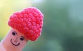 Funny finger puppet with raspberry hat Royalty Free Stock Photo