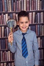 Funny first-grader boy with a magnifying glass Royalty Free Stock Photo