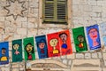 Funny flags on vintage street of European city. Pennants and banners with funny faces of people. Tourist festival, holiday. Old Royalty Free Stock Photo