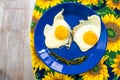 Funny food face smile fried eggs eyes vegetable mouth blue dish Royalty Free Stock Photo