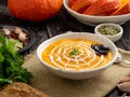 Funny food for Halloween. Pumpkin puree soup, spider web, dark old wooden table, side view. Royalty Free Stock Photo