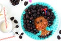Funny food idea for children edible girl, face from pancake, gooseberry and blackberry, food art