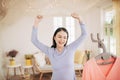 Funny foxy woman dancing with steamer iron. Housewife having fun while ironing clothes