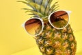 Funny fresh pineapple wearing sunglasses.