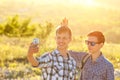 Funny friends guys are photographed on phone selfie on a Sunny day