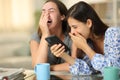 Funny friends watching media on phone laughing loud