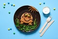 Funny frog made of pancakes on a plate, top view. Breakfast for children. Lunch to school
