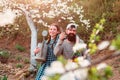 Funny gardener couple holding garden tools at spring nature background. Spring couple in love.