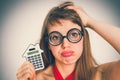 Funny geek or nerd school woman with calculator in her hand Royalty Free Stock Photo