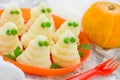 Funny ghosts from mashed potatoes and green peas, creative dinner dish for Halloween Royalty Free Stock Photo