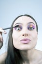 Funny girl applying mascara Royalty Free Stock Photo