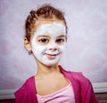 Funny girl with big head and cosmetic cleansing mask Royalty Free Stock Photo