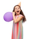 funny girl in birthday party hat blowing balloon Royalty Free Stock Photo