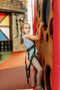 Funny girl climbing walls in children game center