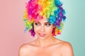 Funny girl clown. Rainbow wig. Funny, laughing, happy girl. Royalty Free Stock Photo