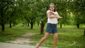 Funny girl dancing outdoors. Concentrated teen girl making rhythmical movements.