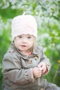 Funny girl with Down syndrome in the mouth pulls dandelions Royalty Free Stock Photo